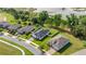Aerial view of homes with green lawns, lush landscaping, and a peaceful street in a Gathering-friendly neighborhood at 358 Irving Bend Dr, Groveland, FL 34736
