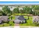 Aerial view of home featuring a well-maintained lawn, fenced backyard and stunning water views at 358 Irving Bend Dr, Groveland, FL 34736