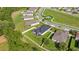 Aerial view of homes with solar panels, green lawns, lush landscaping, and a peaceful street in a Gathering-friendly neighborhood at 358 Irving Bend Dr, Groveland, FL 34736