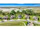 Aerial view of homes featuring mature trees, green lawns, and picturesque water views in a quiet neighborhood at 358 Irving Bend Dr, Groveland, FL 34736