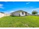 Lush green backyard featuring a well-maintained lawn and a privacy fence at 358 Irving Bend Dr, Groveland, FL 34736