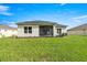 Well-maintained backyard with a screened lanai, lush grass, and a modern exterior at 358 Irving Bend Dr, Groveland, FL 34736