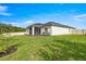 Spacious backyard with lush green grass, screened lanai and a privacy fence at 358 Irving Bend Dr, Groveland, FL 34736