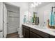 Modern bathroom with double sink vanity and shower-tub combo at 358 Irving Bend Dr, Groveland, FL 34736
