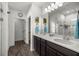 Bathroom featuring a double vanity with modern fixtures and a walk-in shower at 358 Irving Bend Dr, Groveland, FL 34736