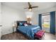 Comfortable bedroom featuring a ceiling fan, window and carpet at 358 Irving Bend Dr, Groveland, FL 34736