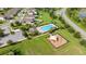 Aerial view of community pool, playground, and lush green space in a well-maintained neighborhood at 358 Irving Bend Dr, Groveland, FL 34736