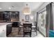 Bright dining area features an elegant light fixture, view to the backyard, and seamless flow into the kitchen at 358 Irving Bend Dr, Groveland, FL 34736