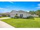 Inviting single-story home with lush green lawn and neatly trimmed hedges at 358 Irving Bend Dr, Groveland, FL 34736