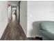 Long hallway with wood flooring leading to a bright living space, providing a sense of depth and openness at 358 Irving Bend Dr, Groveland, FL 34736