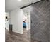 Hallway featuring stylish barn door accent and attractive wood-look flooring at 358 Irving Bend Dr, Groveland, FL 34736