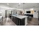 Open kitchen with a large island, modern lighting, and an adjacent dining and living area at 358 Irving Bend Dr, Groveland, FL 34736