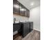 Laundry room with washer, dryer, utility sink, and ample cabinet space at 358 Irving Bend Dr, Groveland, FL 34736