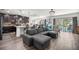 Spacious open-concept living room with modern furniture, adjacent kitchen, and access to the outdoor patio at 358 Irving Bend Dr, Groveland, FL 34736