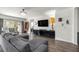 Spacious living room offers hardwood floors, a modern ceiling fan, and sliding glass doors to the outdoor patio at 358 Irving Bend Dr, Groveland, FL 34736
