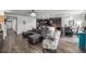 Open-concept living space showcases modern gray furniture, a dining area, and views of the kitchen at 358 Irving Bend Dr, Groveland, FL 34736