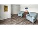Inviting living room with two plush armchairs and stylish wood-look flooring at 358 Irving Bend Dr, Groveland, FL 34736