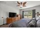 Comfortable main bedroom with a ceiling fan, large window, and hardwood floors at 358 Irving Bend Dr, Groveland, FL 34736