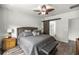Comfortable main bedroom with a ceiling fan, large window, and hardwood floors at 358 Irving Bend Dr, Groveland, FL 34736