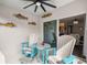 Relaxing patio featuring Adirondack chairs, a table, decorative fish, and a ceiling fan at 358 Irving Bend Dr, Groveland, FL 34736