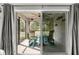 View from home into the screened lanai featuring comfortable seating and relaxing views of the lush greenery at 358 Irving Bend Dr, Groveland, FL 34736