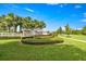 Community entrance sign with manicured landscaping and a clear blue sky backdrop at 358 Irving Bend Dr, Groveland, FL 34736