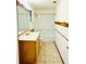 This bathroom features a large mirror, wood vanity, and shower-tub combo at 3610 Sw 25Th Pl, Ocala, FL 34474