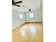 This bedroom has hardwood floors, white walls, and 2 windows for natural light at 3610 Sw 25Th Pl, Ocala, FL 34474
