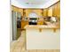 Well-equipped kitchen with wood cabinets, tile countertops, and stainless steel appliances at 3610 Sw 25Th Pl, Ocala, FL 34474