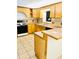 Well-equipped kitchen with wood cabinets, tile countertops, and updated appliances at 3610 Sw 25Th Pl, Ocala, FL 34474