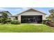 The home features a screened-in porch overlooking the landscaped backyard at 4232 Nw 56Th Ct, Ocala, FL 34482