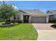 Well-maintained single-story home with a manicured lawn, two-car garage, and a welcoming front entrance at 4232 Nw 56Th Ct, Ocala, FL 34482