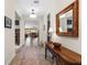 Inviting hallway features a decorative rug and leads to the living area with neutral tones and ample natural light at 4232 Nw 56Th Ct, Ocala, FL 34482