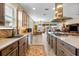 Gourmet kitchen featuring stone countertops, stainless steel appliances, and a center island cooktop at 4232 Nw 56Th Ct, Ocala, FL 34482