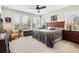 Bedroom with a ceiling fan, large windows, and neutral walls providing plenty of natural light at 4232 Nw 56Th Ct, Ocala, FL 34482