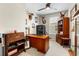 Well-lit office space with traditional wood furniture, ceiling fan, and large window offering a comfortable workspace at 4232 Nw 56Th Ct, Ocala, FL 34482