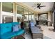 This covered patio features an outdoor seating area and a ceiling fan for comfortable outdoor living at 4232 Nw 56Th Ct, Ocala, FL 34482