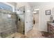 Modern shower with glass door, tiled walls, pebble floor, and rain shower head; bright and clean at 4232 Nw 56Th Ct, Ocala, FL 34482