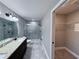 The ensuite bathroom showcases dual sinks, a granite counter, and a large walk-in glass shower at 5320 Sw 128Th Pl, Ocala, FL 34473