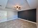 Bedroom with gray walls, a ceiling fan, and tile flooring at 5320 Sw 128Th Pl, Ocala, FL 34473