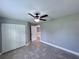 Bedroom featuring tile floors, gray walls, and double door closets at 5320 Sw 128Th Pl, Ocala, FL 34473