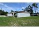 Exterior view of the home with green grass and lush landscaping at 5320 Sw 128Th Pl, Ocala, FL 34473