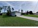 This home features a two car garage with plenty of yard space and a concrete driveway at 5320 Sw 128Th Pl, Ocala, FL 34473