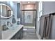 Modern bathroom featuring a glass bowl sink, decorative tiling in the shower, and a lighted mirror at 5845 Sw 43Rd Street Rd, Ocala, FL 34474