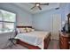 Bright bedroom with a ceiling fan, window with blinds, wood furniture and neutral color scheme at 5845 Sw 43Rd Street Rd, Ocala, FL 34474