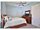Comfortable bedroom features a ceiling fan, neutral paint and trim, and classic wood furniture at 5845 Sw 43Rd Street Rd, Ocala, FL 34474