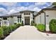 Impressive home with landscaped walkway leading to a striking modern front door at 5845 Sw 43Rd Street Rd, Ocala, FL 34474