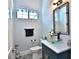 Contemporary half bathroom has a unique glass vessel sink, decorative mirror, and tile flooring at 5845 Sw 43Rd Street Rd, Ocala, FL 34474