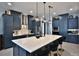 Beautiful kitchen with ample counter space, a large island with seating, and stylish lighting fixtures at 5845 Sw 43Rd Street Rd, Ocala, FL 34474