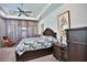 Comfortable primary bedroom features a ceiling fan, soft carpet, natural light, and a king-size bed at 5845 Sw 43Rd Street Rd, Ocala, FL 34474